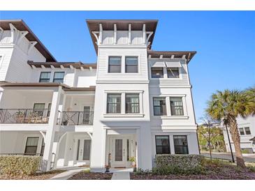 Bright and modern three-story townhome with eye-catching architectural features, including a tower and balconies at 5351 Bridge St # 41, Tampa, FL 33611