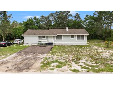 Charming single-story home with a welcoming front porch, a driveway, and a well-maintained yard at 12651 Tinley Rd, New Port Richey, FL 34654