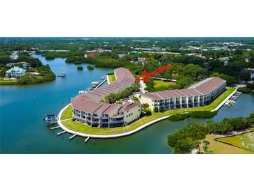 Stunning aerial view of waterfront condo community with private docks and lush landscaping on Tampa Bay at 152 Brent Cir, Oldsmar, FL 34677