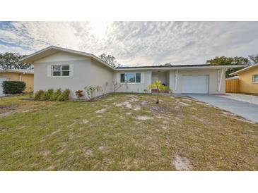 Charming single-story home featuring a well-manicured lawn and an attached one car garage at 1364 S Evergreen Ave, Clearwater, FL 33756