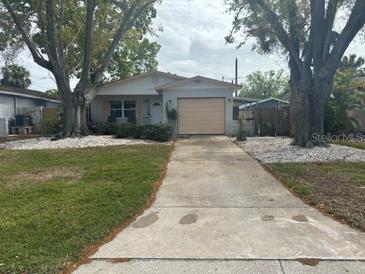 Charming single-story home with well-maintained front yard and mature trees at 1774 Michigan Ne Ave, St Petersburg, FL 33703