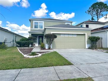 Charming two-story home with well-maintained landscaping and an attached two-car garage at 1112 Lake Shore Ranch Dr, Seffner, FL 33584