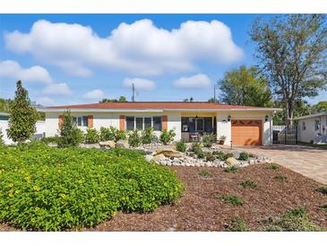 Charming one-story home with a well-manicured lawn, rock garden, and cozy front porch at 8467 8Th N Way, St Petersburg, FL 33702