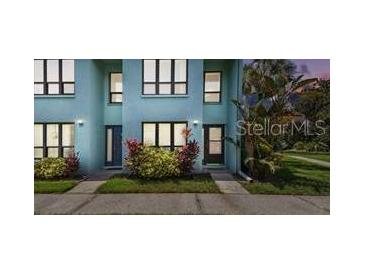 Charming two-story townhome with a beautifully landscaped front yard and a welcoming entrance at 20890 Negril Ct # 5, Lutz, FL 33558
