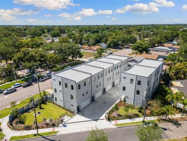 Modern townhome complex featuring clean lines and a neutral color palette in a well-landscaped neighborhood at 2205 16Th N St, St Petersburg, FL 33704