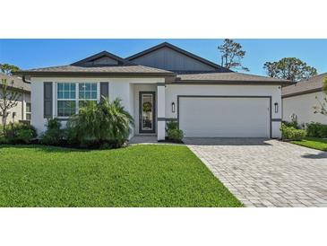 Charming single-Gathering home with a well-maintained lawn and a neutral color scheme at 1848 Sunset Preserve Way, Port Charlotte, FL 33953