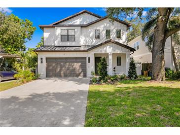 Charming two-story home featuring a well-maintained lawn, a two-car garage, and a welcoming front entrance at 3618 W Royal Palm Cir, Tampa, FL 33629