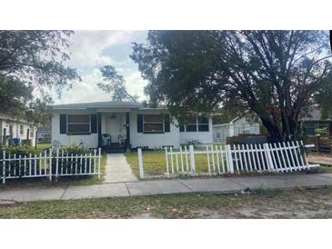 Charming single-story home featuring a classic white picket fence and inviting front porch at 4142 12Th S Ave, St Petersburg, FL 33711