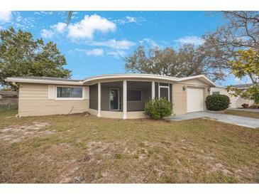 Charming single-story home with a screened porch and attached one-car garage at 5317 Tammy Ln, Holiday, FL 34690