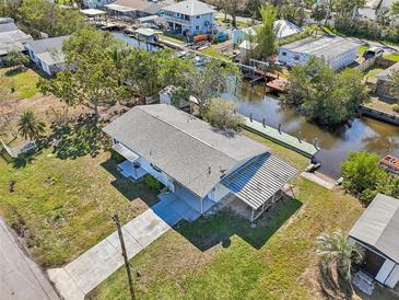 Aerial view of the property with a dock and canal access, lush greenery, and convenient waterfront living at 106 W North Branch Rd, Ruskin, FL 33570