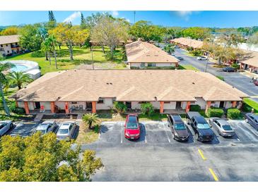 Community of townhomes with a pool and parking spaces available for residents and visitors at 13250 Ridge Rd # 10-4, Largo, FL 33778