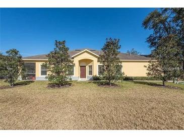 Charming one-story home with a well-manicured lawn and young trees lining the front at 6359 Timberly Ln, Zephyrhills, FL 33542