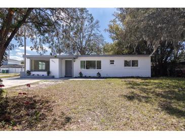 Charming single-story home with a well-manicured lawn and neatly trimmed bushes at 3017 E Jean St, Tampa, FL 33610