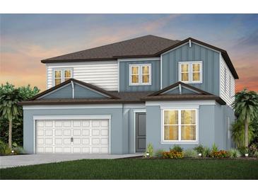 Charming two-story home with a two-car garage, a mix of siding, and meticulously manicured landscaping at 37244 Clinch Cir, Zephyrhills, FL 33540
