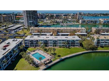 Stunning aerial view of the condominium, pool, and waterfront, showcasing the building's unique location at 7405 Bay Island S Dr # 220, South Pasadena, FL 33707