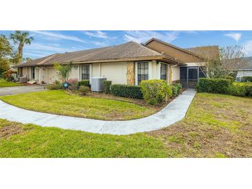 Charming single-story home featuring a well-manicured lawn and a welcoming walkway leading to the entrance at 7703 Rockville Ct # 0, New Port Richey, FL 34654