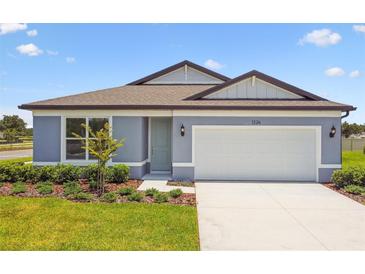 Charming single-story home featuring a two-car garage, manicured lawn, and welcoming curb appeal at 1226 Mumford Ct, Zephyrhills, FL 33540