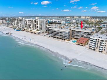 Stunning aerial view of beachfront condo with pristine sands and turquoise waters at 14900 Gulf Blvd # 304, Madeira Beach, FL 33708