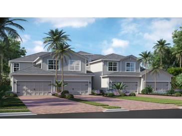 Beautiful townhome exteriors featuring modern design, two-car garages, and tropical landscaping, creating curb appeal at 17745 Boracay Ct # 19-202, Venice, FL 34293