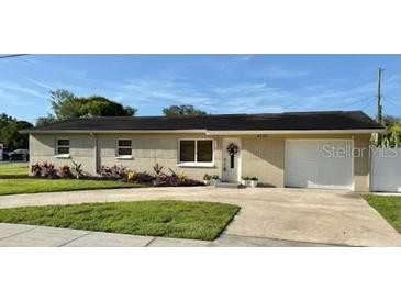 Charming single story home with white brick and a well-maintained lawn and front garden at 6310 57Th N Ave, St Petersburg, FL 33709