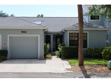 Charming single-story home featuring a one car garage, well maintained lawn and beautiful front door at 992 San Carlos Ne Ct, St Petersburg, FL 33702