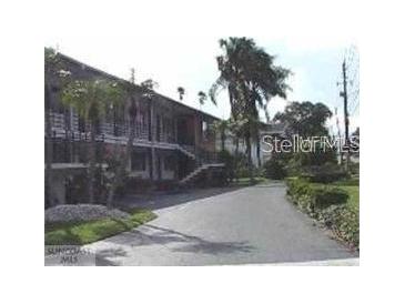 Inviting exterior of a multi-story home with a well-maintained lawn and driveway at 1345 Drew St # 5, Clearwater, FL 33755
