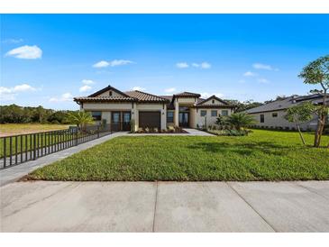 Charming home features a manicured lawn, tile roof and neutral color palette at 15539 Stuart Cir, Port Charlotte, FL 33981