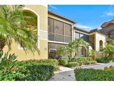Beautiful condominium exterior featuring screened in porch with a lush landscaped walkway at 7305 River Hammock Dr # 204, Bradenton, FL 34212