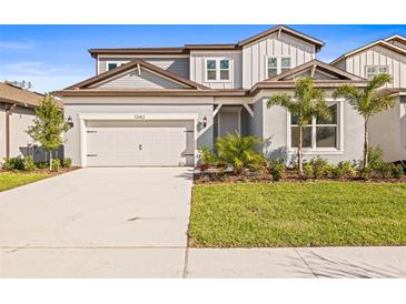Charming two-story home with well-manicured lawn, lush landscaping, and attached two car garage at 12652 Glenn Creek Dr, Riverview, FL 33569