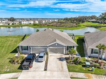 Stunning aerial view of a home with water view and two-car garage, showcasing its prime location within the community at 31251 Mango Fade Way, San Antonio, FL 33576