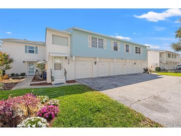 Charming two-story townhouse featuring attached garages and vibrant landscaping at 3280 39Th S St # B, St Petersburg, FL 33711