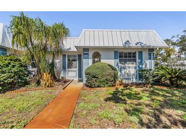 Charming single-story home with well-maintained landscaping, vibrant lawn and metal roof at 4215 Regal Pl, New Port Richey, FL 34652