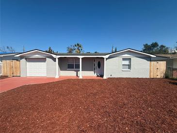 Charming single-story home with freshly mulched front yard and a brick facade at 4731 Foothill Dr, Holiday, FL 34690