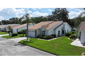 Charming single-story home featuring a well-manicured lawn, a tile roof, and an attached two-car garage at 5839 Garden Lakes Dr, Bradenton, FL 34203