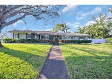 Charming single-story home with a well-manicured lawn and inviting walkway at 6300 6Th N Ave, St Petersburg, FL 33710