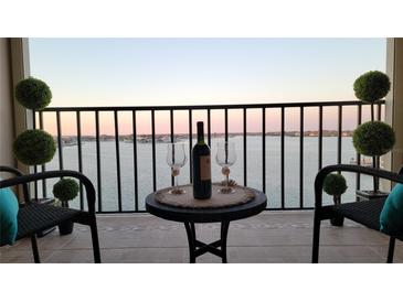 Inviting balcony with comfortable seating offers serene water views, perfect for relaxation and enjoying sunsets at 7700 Sun Island S Dr # 608, South Pasadena, FL 33707