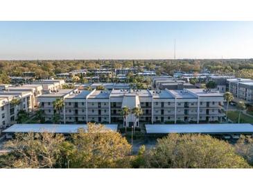 Wide aerial view of the condo community, with lush landscaping and well-maintained buildings at 8681 Bardmoor Blvd # 208C, Seminole, FL 33777