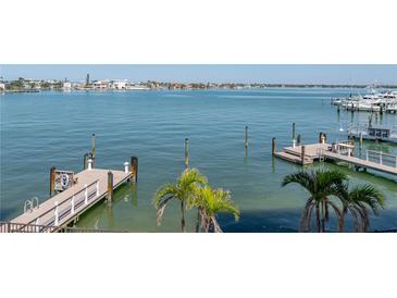 Scenic waterfront view featuring docks and boats under a bright blue sky at 240 108Th Ave # 102, Treasure Island, FL 33706