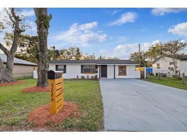 Charming home boasts a well-manicured lawn, long driveway, and eye-catching wooden mailbox at 5220 Pine St, Seffner, FL 33584