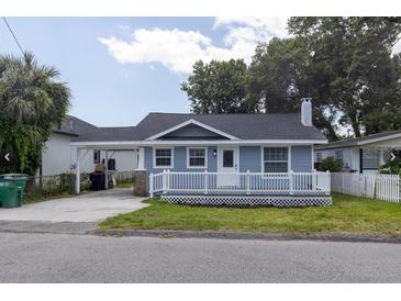 Charming single-story home featuring a cozy front porch and a convenient carport at 6906 N Lynn Ave, Tampa, FL 33604
