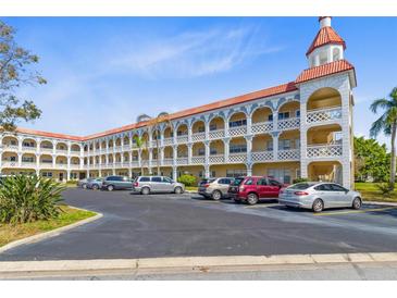 Beautiful condo with a light colored exterior, rows of balconies and ample parking at 2404 Florentine Way # 40, Clearwater, FL 33763