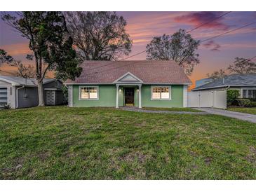 Charming, green single-story home featuring a well-maintained lawn and neutral-toned roof at 5105 W Cleveland St, Tampa, FL 33609
