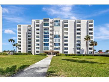 Beautiful condo building with a manicured lawn and landscaping, offering a serene residential setting at 851 Bayway Blvd # 904, Clearwater Beach, FL 33767