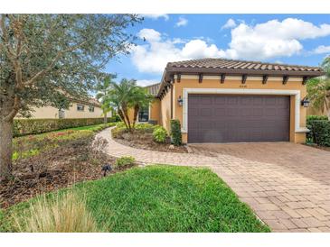 Charming single-Gathering home featuring a well-manicured lawn and a private two-car garage at 10446 Highland Park Pl, Palmetto, FL 34221