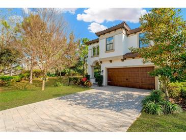 Stunning two-story home featuring a paver driveway and a spacious two-car garage at 13040 Burns Dr, Odessa, FL 33556