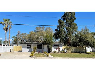 Charming single-story home featuring a well-maintained lawn and freshly painted exterior at 5751 94Th N Ave, Pinellas Park, FL 33782
