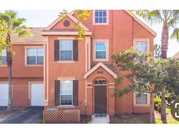 Charming townhouse with an inviting entrance, complemented by lush tropical landscaping and a cozy front porch area at 10450 White Lake Ct # 44, Tampa, FL 33626