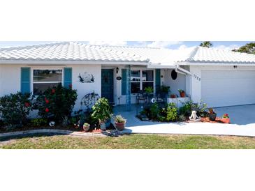 Home with a white tile roof and a tidy front yard at 1320 Bottlebrush Dr, Bradenton, FL 34208