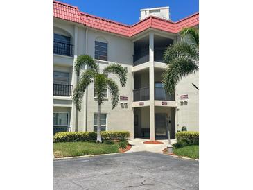 Well-maintained condominium exterior with lush landscaping and covered walkways at 2700 Bayshore Blvd # 2308, Dunedin, FL 34698