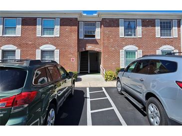 A brick condo building with white trim windows and assigned parking at 3934 37Th S St # 36, St Petersburg, FL 33711